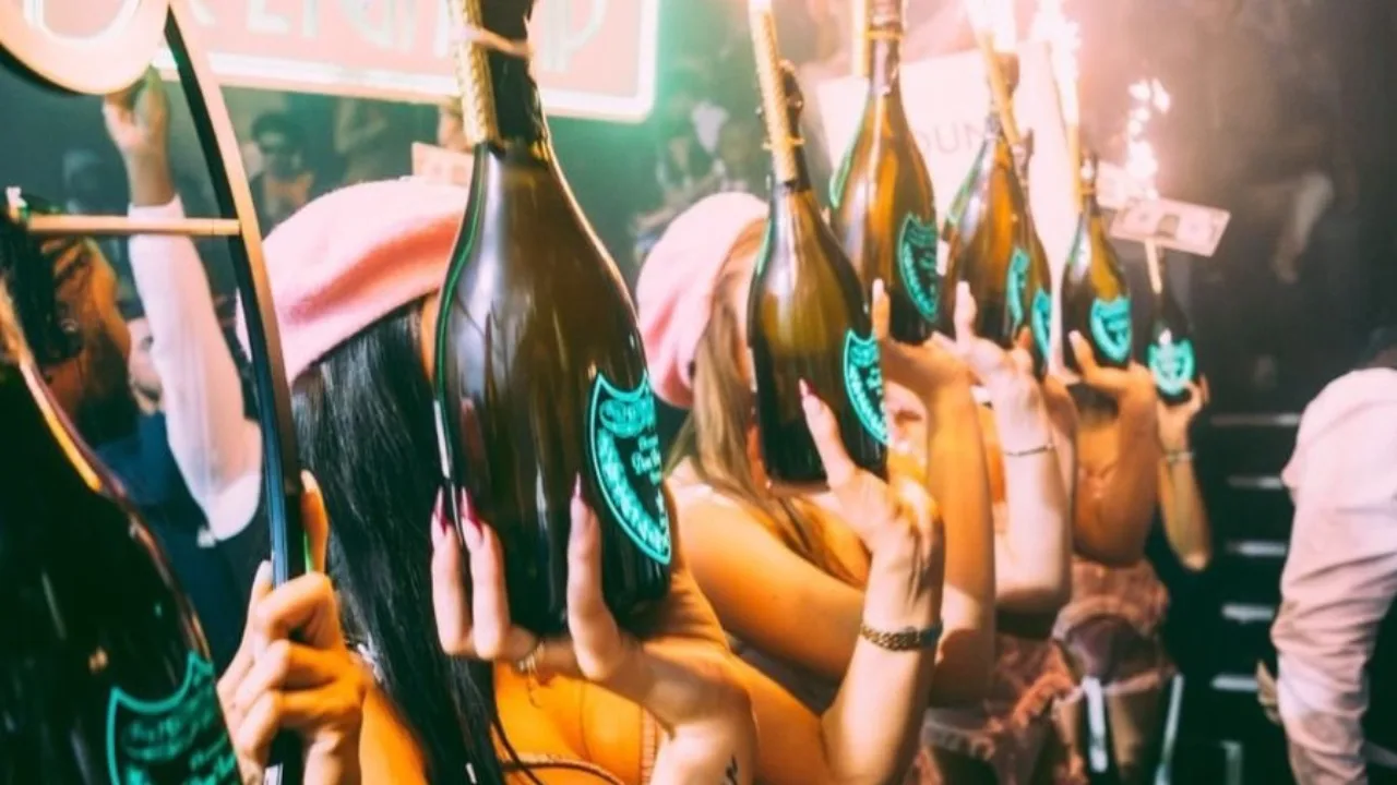Champagne bottle parade with sparklers at Reign Showclub London